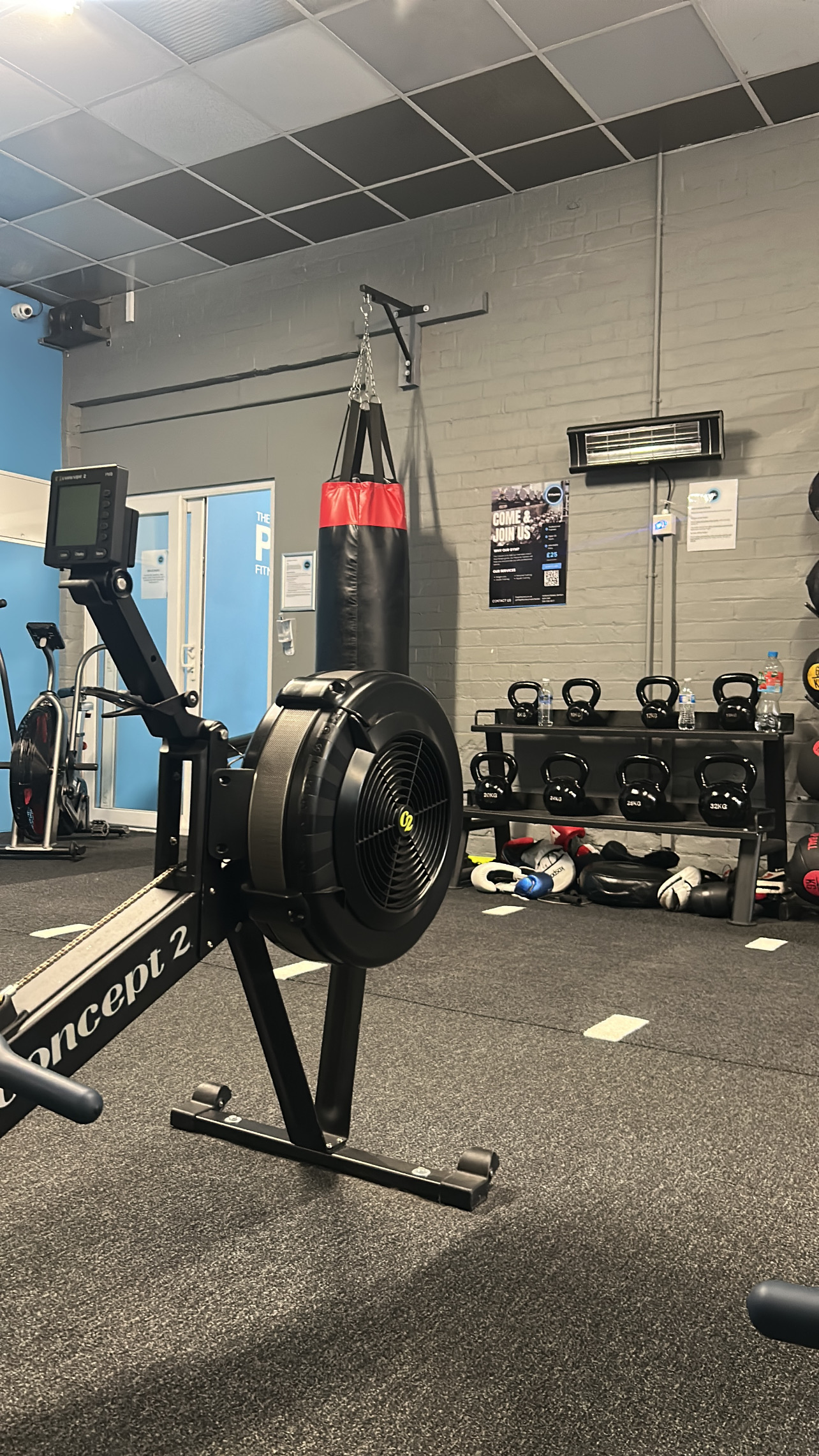 PT Factory gym in Denton, Manchester — rowing machine, boxing bag and weights